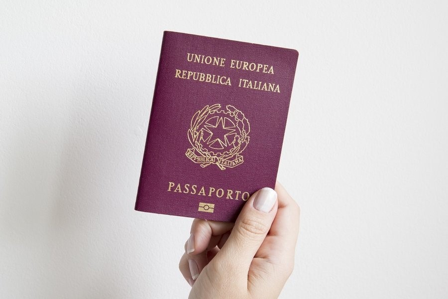 person holding Italian passport