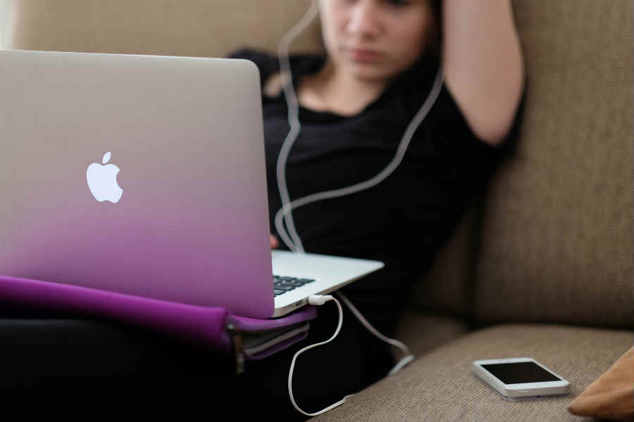 Student on Laptop on Sofa