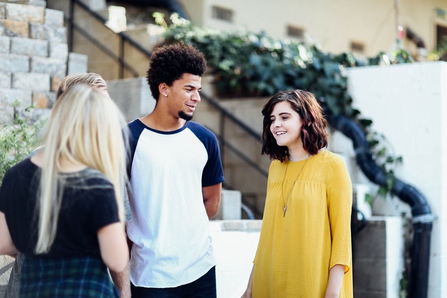 young group of friends talking together