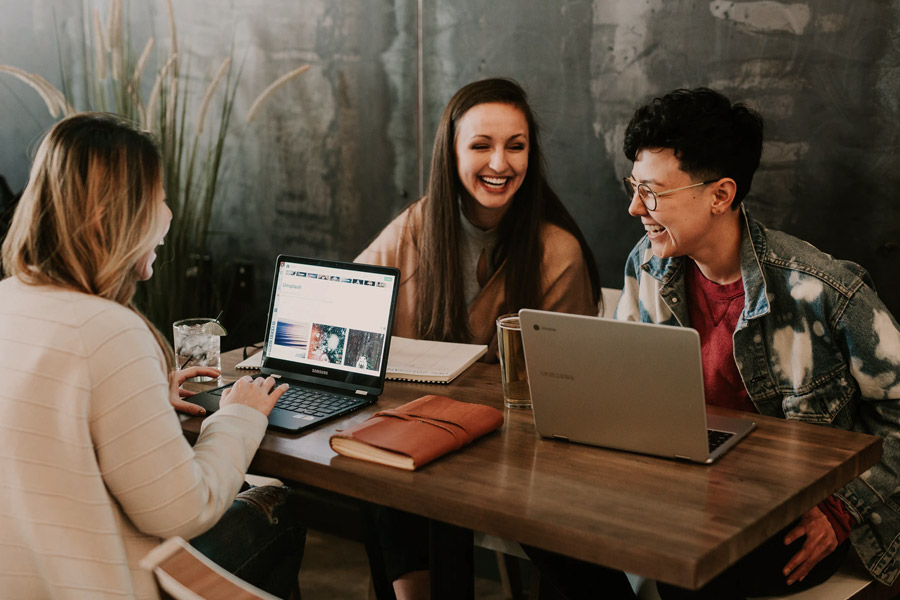 group of friends talking and laughing around a table