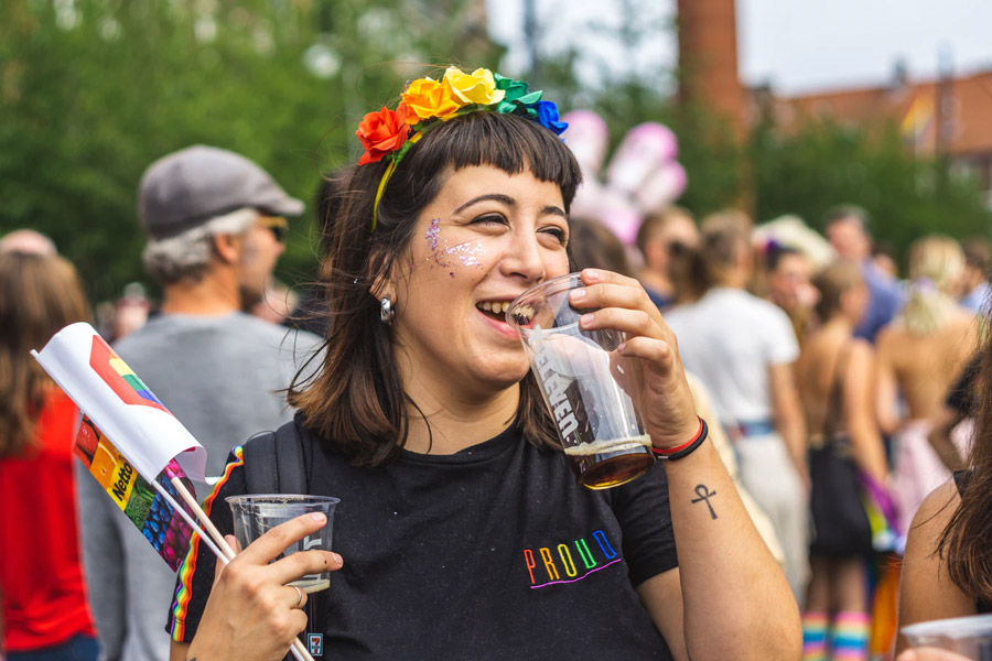 girl at a gay pride parade with rainbow flag