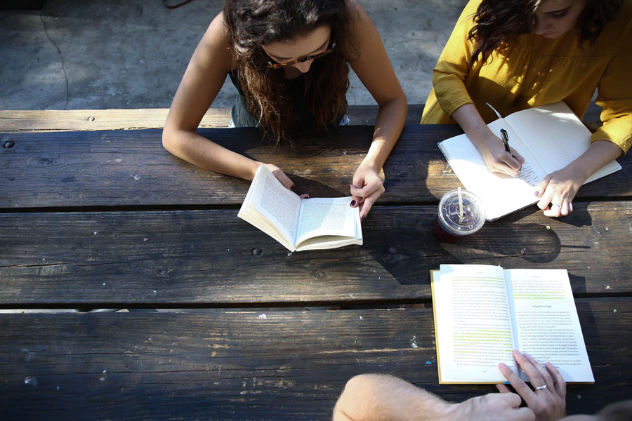 Group of students around a table studying