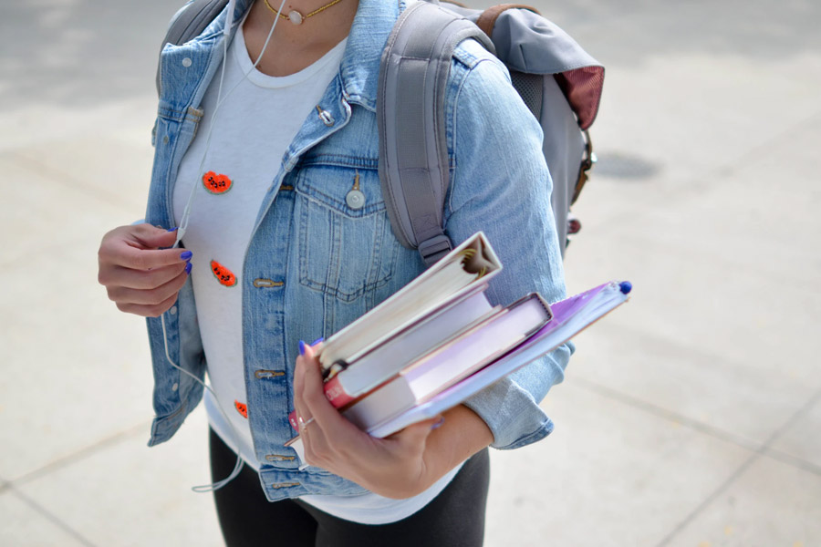 Female student with backpack and books