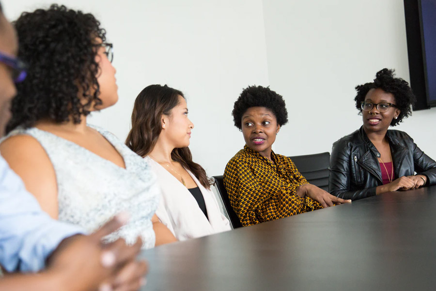 group of women talking around a table